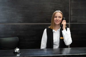 Nell'immagine una ragazza che risponde al telefono in reception